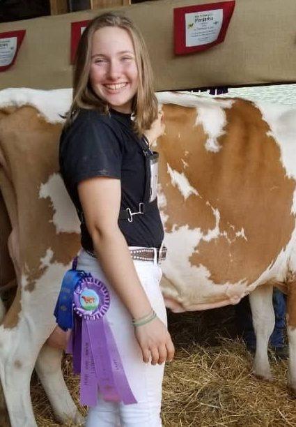 Mackenzie Blatt posing with her award winning cow